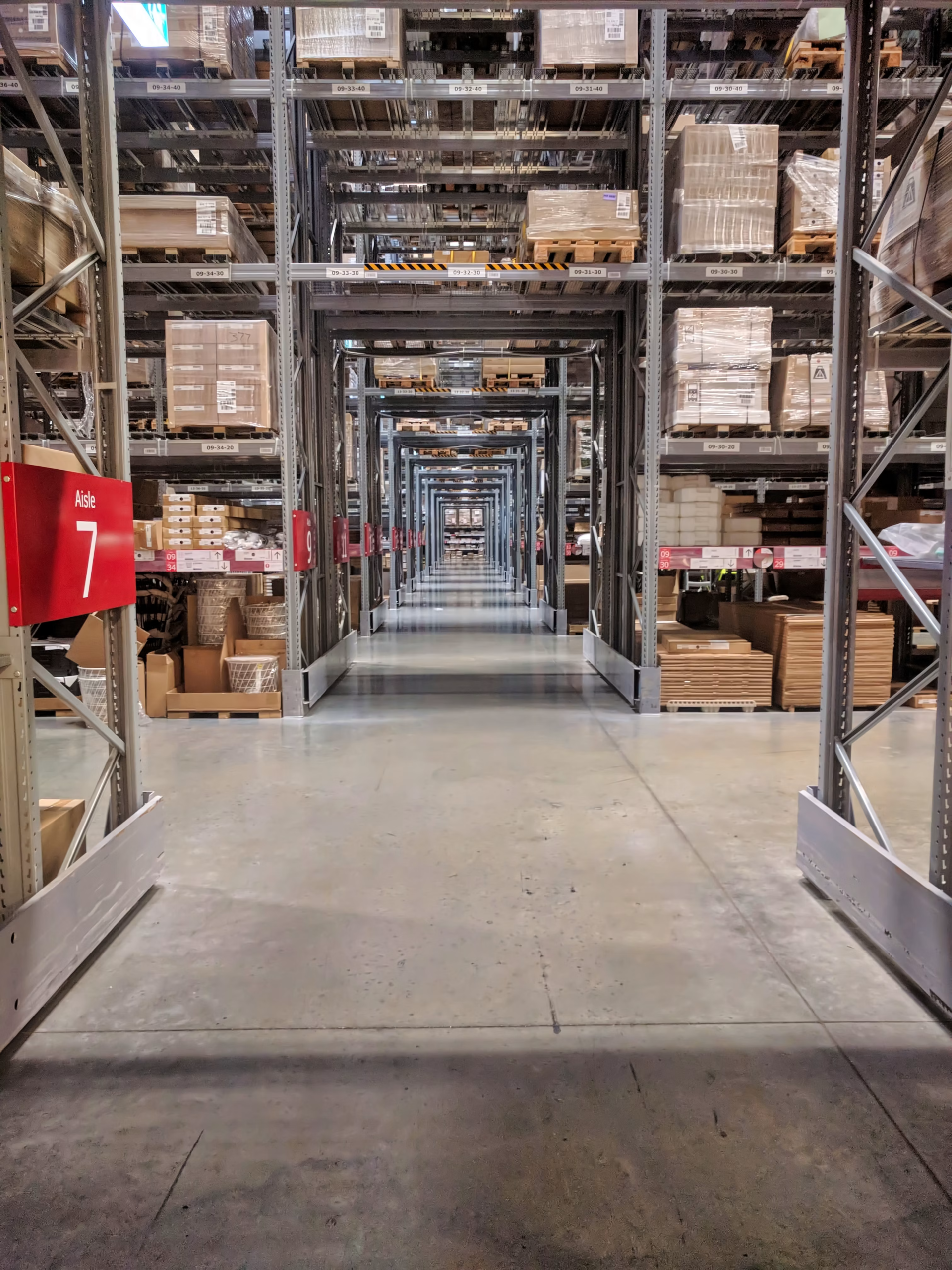 Warehouse racking aisle stocked with boxed goods